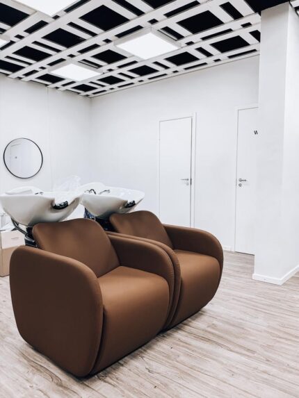 “Leather salon chair with hydraulic pump and swivel base”