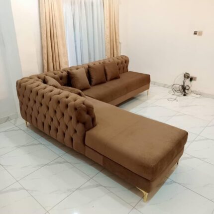 Its spacious L-shaped design makes it ideal for family lounging or entertaining guests, while the button detailing adds a timeless touch of sophistication. Available in a variety of fabrics and colors, this couch brings luxury and warmth to any living room.