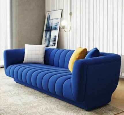 “Three-seater blue velvet sofa by King’s Touch Furniture with cushioned seats and modern design.”