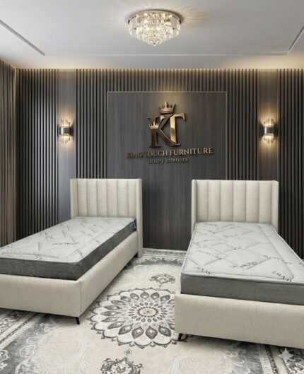 A pair of elegant cream linen Vertical Channel Single Beds by King Touch Furniture, featuring high-profile wingback headboards with vertical paneling, styled in a luxury bedroom with a wood-slat feature wall and crystal chandelier.
